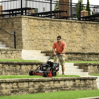 Municipal worker mowing a pavilion with Commercial 30 X-Series Walk-Behind Mower.