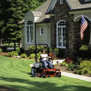 Landscaper mowing lawn on a Exmark Radius E-Series commercial zero-turn mower