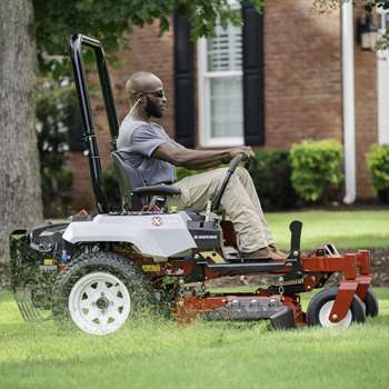 Professional landscaper using an Exmark Radius E-Series commercial zero-turn mower