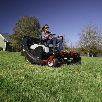 Homeowner mowing lawn on a Exmark Quest S-Series 54-inch Residential zero-turn mower
