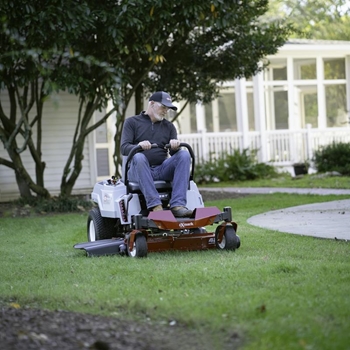Man mowing his lawn with a Quest E-Series residential mower