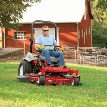 Landscaper mowing grass on a Exmark Lazer-Z S-Series zero-turn mower.