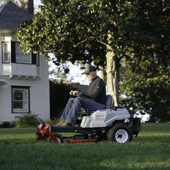 Homeowner mowing lawn on a Exmark Quest E-Series residential zero-turn mower