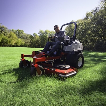 Landscape professional using a Lazer Z X-Series Diesel zero-turn mower to mow a field